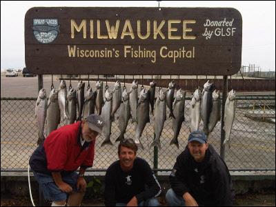 group of 3 in front of their fishing haul