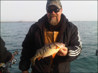 man holding fish on Lake Michigan